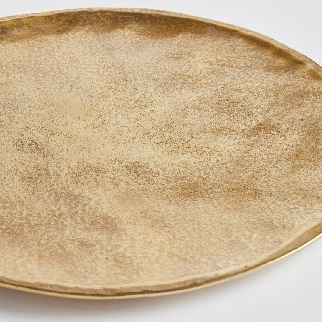 The Veda Decorative Round Tray boasts a modern, rounded form and simple shape, setting it apart from other trays. Its cast aluminum construction ensures durability and elegance, making it a versatile addition to any home decor collection. Use it as a base for candles or with other accent pieces to enhance your contemporary aesthetic.