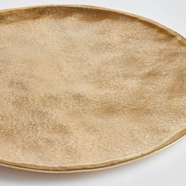 The Veda Decorative Round Tray boasts a modern, rounded form and simple shape, setting it apart from other trays. Its cast aluminum construction ensures durability and elegance, making it a versatile addition to any home decor collection. Use it as a base for candles or with other accent pieces to enhance your contemporary aesthetic.