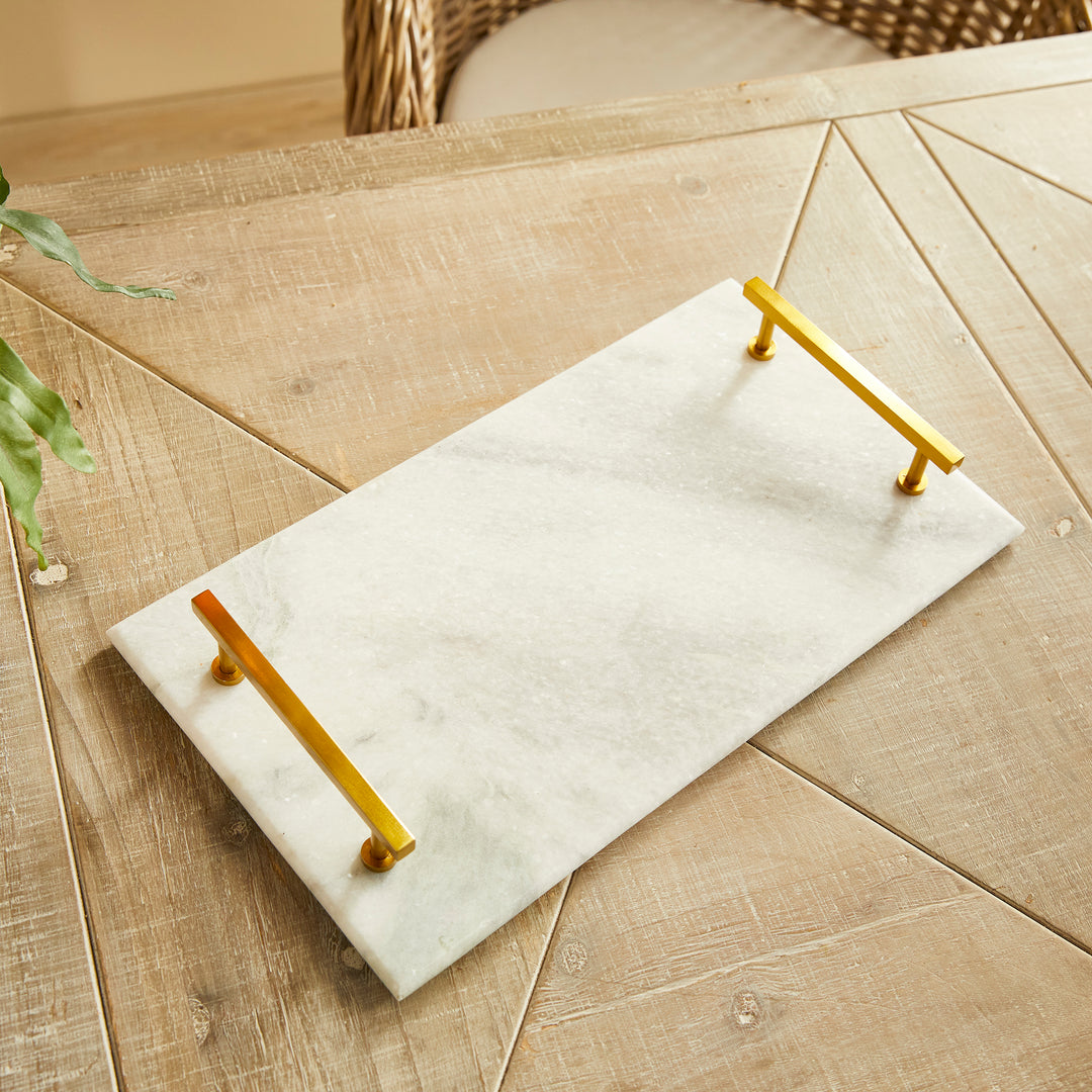 This Marble Serving Tray features a timeless pairing of marble and brass, making it the perfect way to present your favorite cheese and cracker platters. Its versatile design is suitable for coastal, traditional, and transitional settings, elevating your hosting game with a touch of sophistication. Whether you're serving a decadent cheese platter or a simple cracker spread, this tray is sure to impress, adding an elegant touch to any occasion.