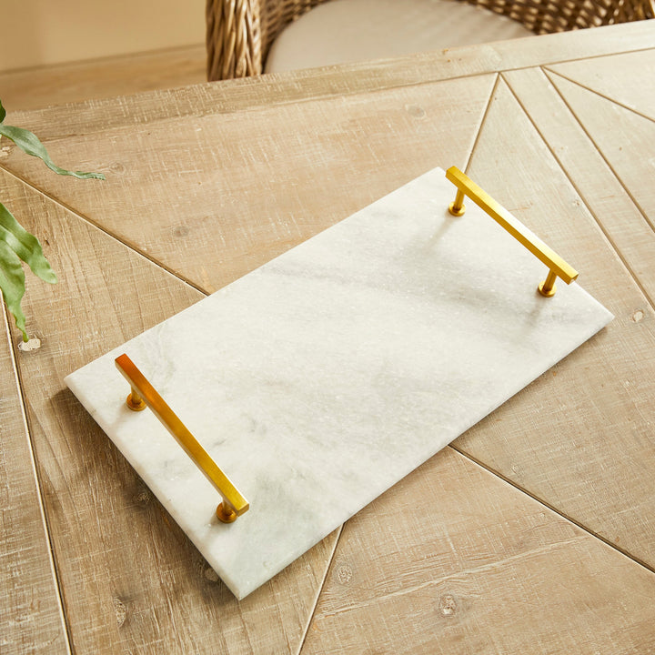 This Marble Serving Tray features a timeless pairing of marble and brass, making it the perfect way to present your favorite cheese and cracker platters. Its versatile design is suitable for coastal, traditional, and transitional settings, elevating your hosting game with a touch of sophistication. Whether you're serving a decadent cheese platter or a simple cracker spread, this tray is sure to impress, adding an elegant touch to any occasion.