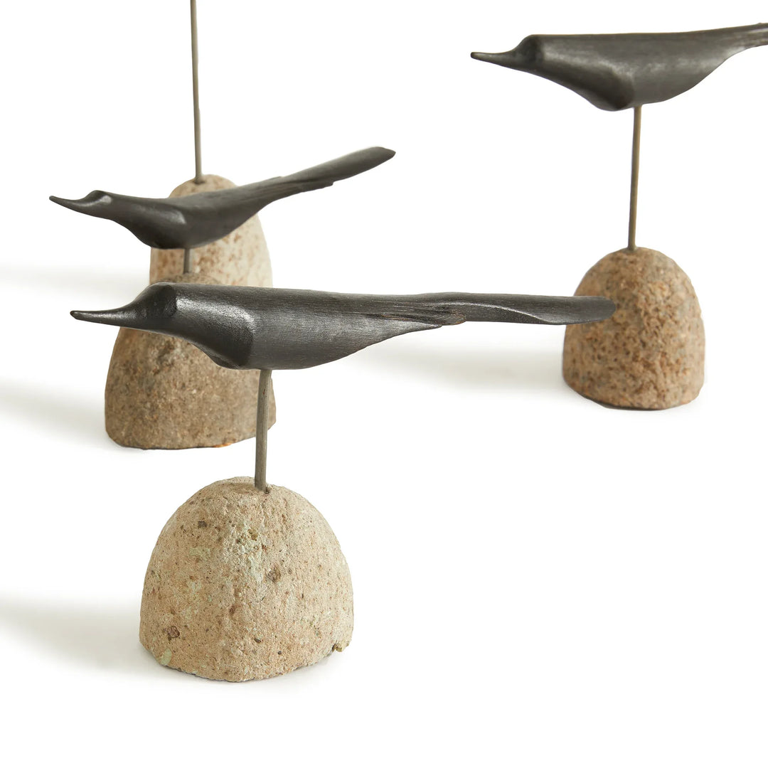 Decorative sculpture of birds on stone bases on a white background