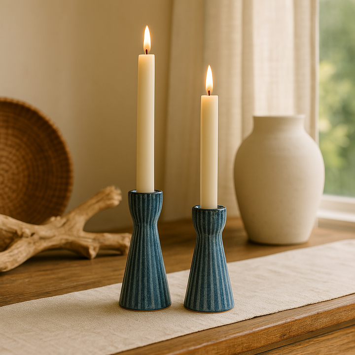 Blue stoneware candle holders shown with warm ambient lighting