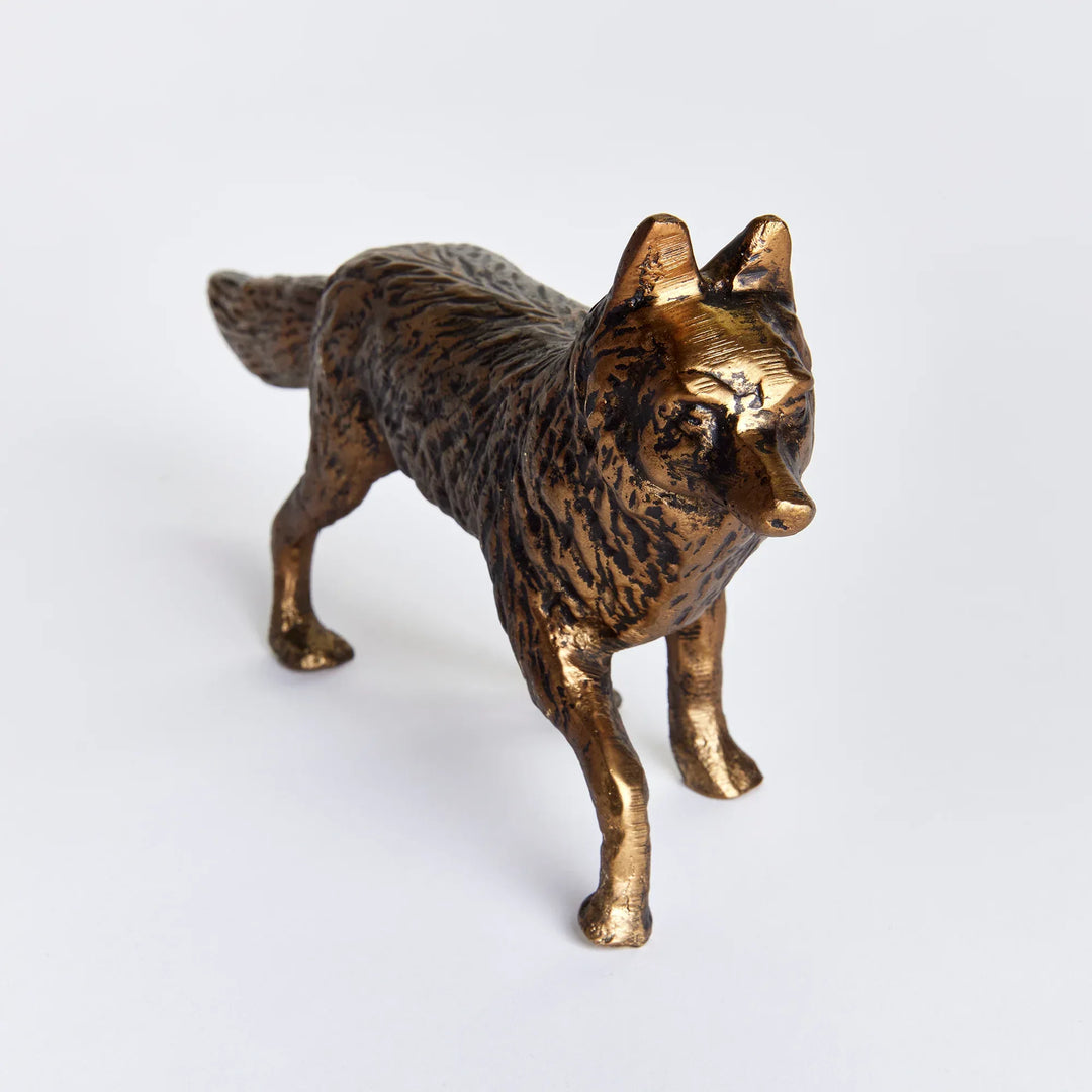 Bronze cat figurine on a white background