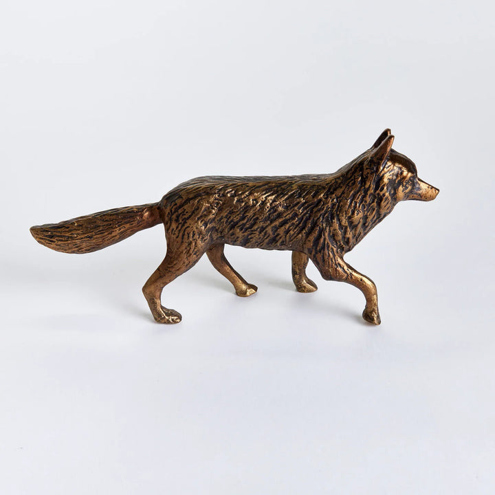 Bronze wolf figurine on a white background
