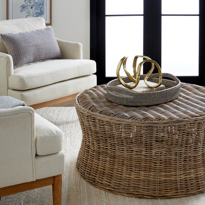 Wicker coffee table with decorative sculpture in a living room setting