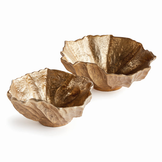 Expertly crafted from durable cast aluminum, these coastal-inspired bowls boast a rounded design reminiscent of seashells. Whether displaying natural orbs or serving as standalone pieces, they add both sophistication and functionality to any space. Perfect for use on an ottoman or side table, these bowls are a must-have for any coastal-themed home.