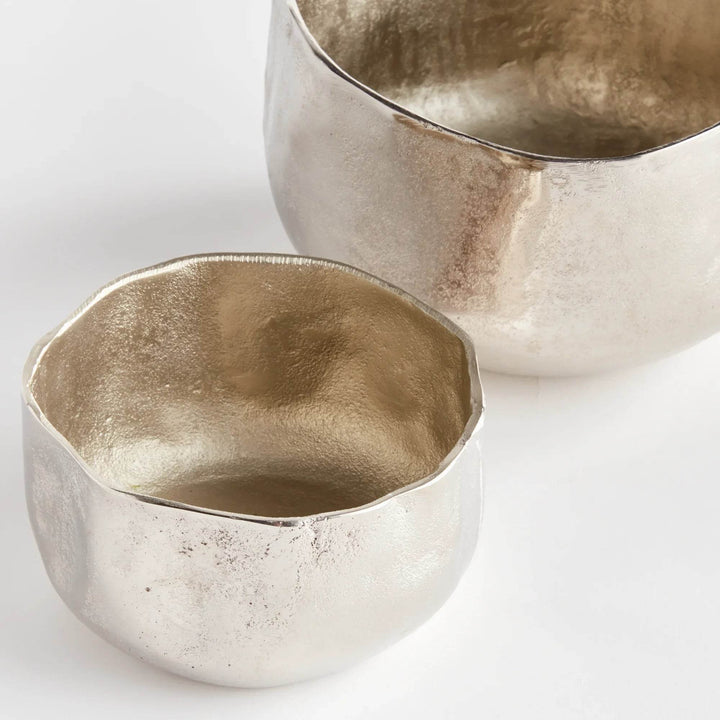 These Silver Metallic Cachepots boast an organic shape and hammered texture, lending a fresh and contemporary look to any room. Perfect for showcasing plants, these cachepots bring a touch of nature to your home in a stylish and sophisticated way.