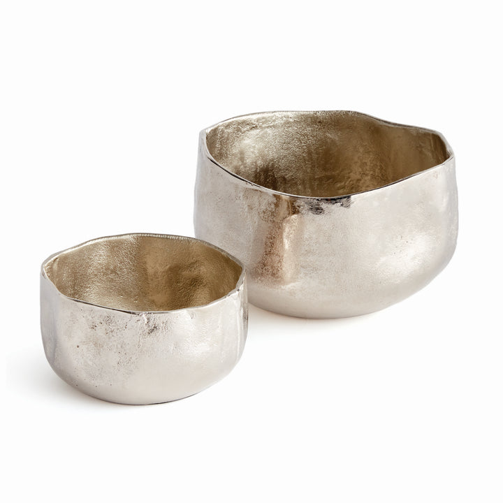 These Silver Metallic Cachepots boast an organic shape and hammered texture, lending a fresh and contemporary look to any room. Perfect for showcasing plants, these cachepots bring a touch of nature to your home in a stylish and sophisticated way.