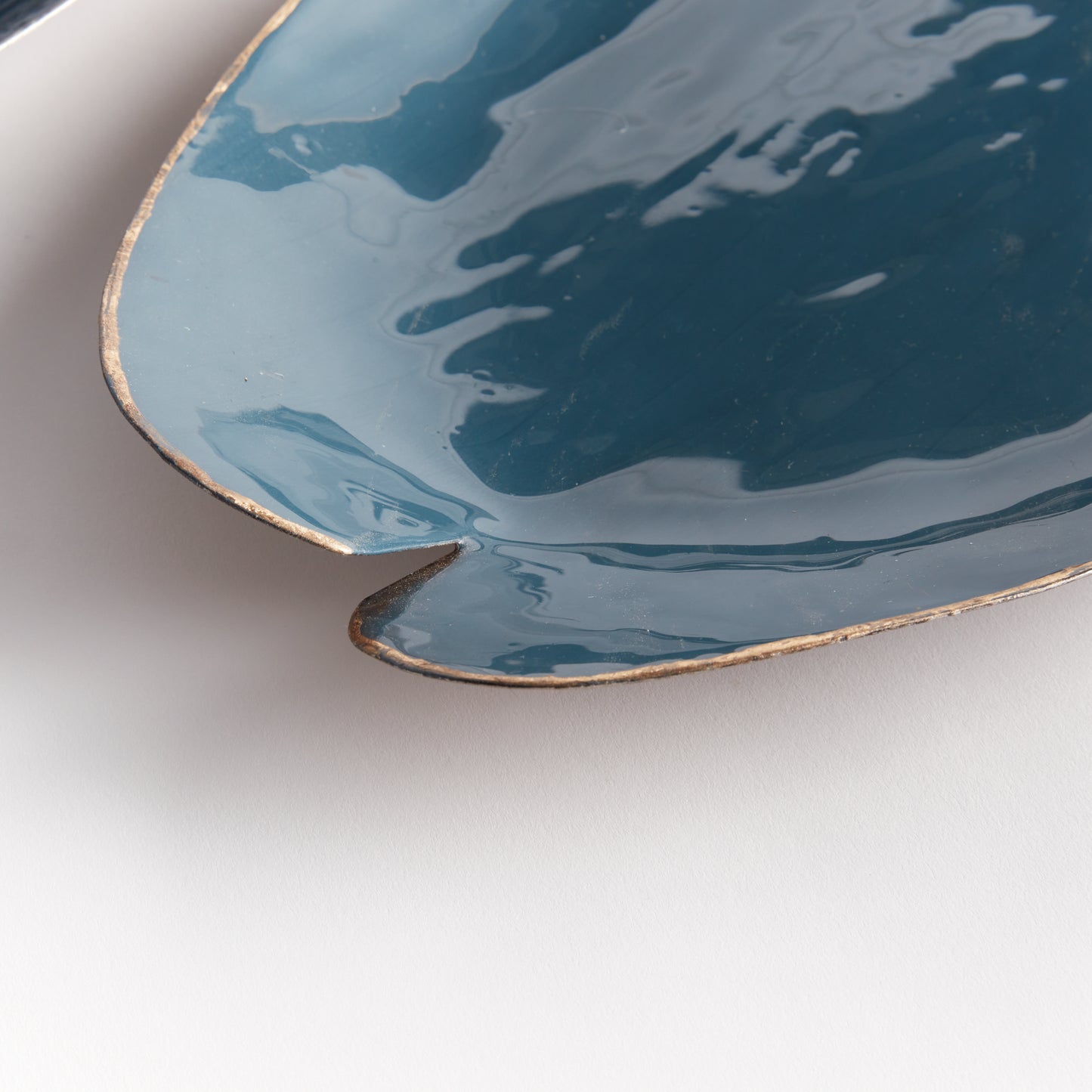 Elevate your home decor with our Camden Blue Coastal Decorative Trays. These expertly hand-painted trays feature a lily pad design and elegant gold edge detail, adding a touch of sophistication to any room. With coordinating soft blue hues, they can be used on a kitchen island, side table, or ottoman to add a pop of character. Each tray is both beautiful and functional, making them a versatile addition to any living space. Discover the charm and elegance of our hand-painted trays today.