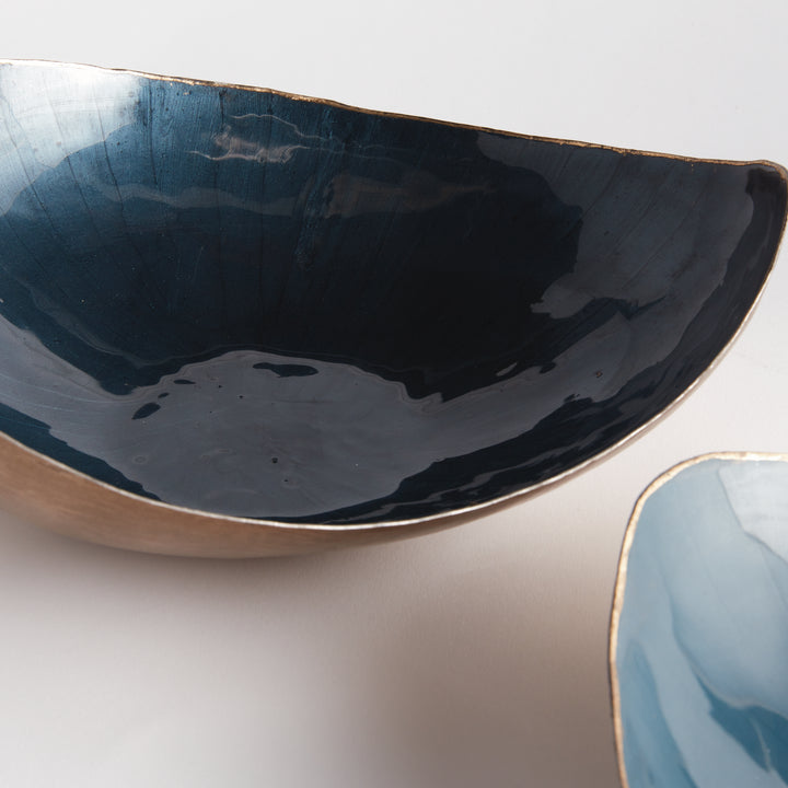 Enhance your home decor with these versatile and chic hand-painted bowls. The stunning gold edge detail complements the soft blue hues, making them the perfect catch-all for jewelry, keys, or spare change. Ideal for any space, these modern decorative bowls add a touch of color and charm. Expertly hand-painted to perfection, they will elevate the look of your kitchen island, side table, or ottoman. Use them to keep your belongings organized and add a stylish touch to your home.