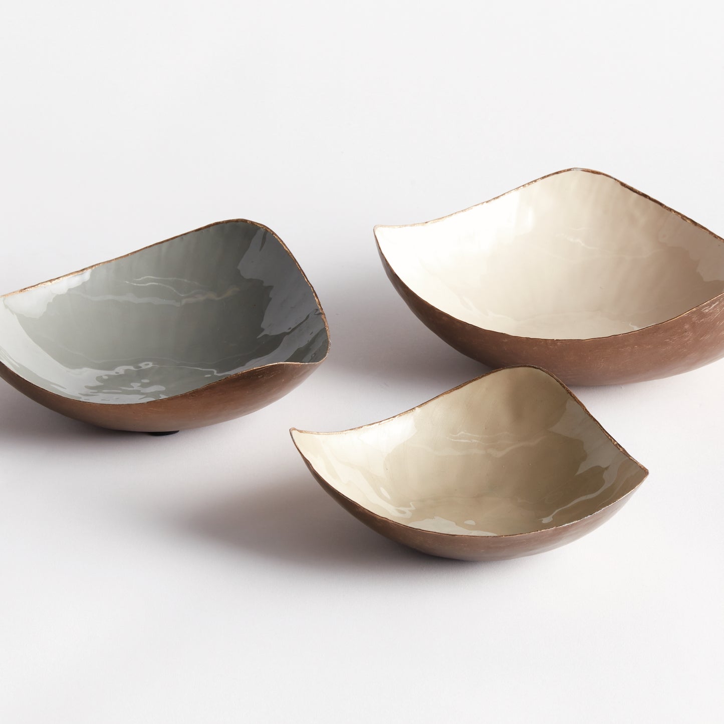 Add a touch of sophistication to your home decor with these delicate hand-painted decorative bowls. Designed with a coordinating gold edge and soft neutral hues, they are versatile enough for use in any room. Perfect for organizing jewelry, keys, or spare change, these bowls add a pop of color to your kitchen island, side table, or ottoman.