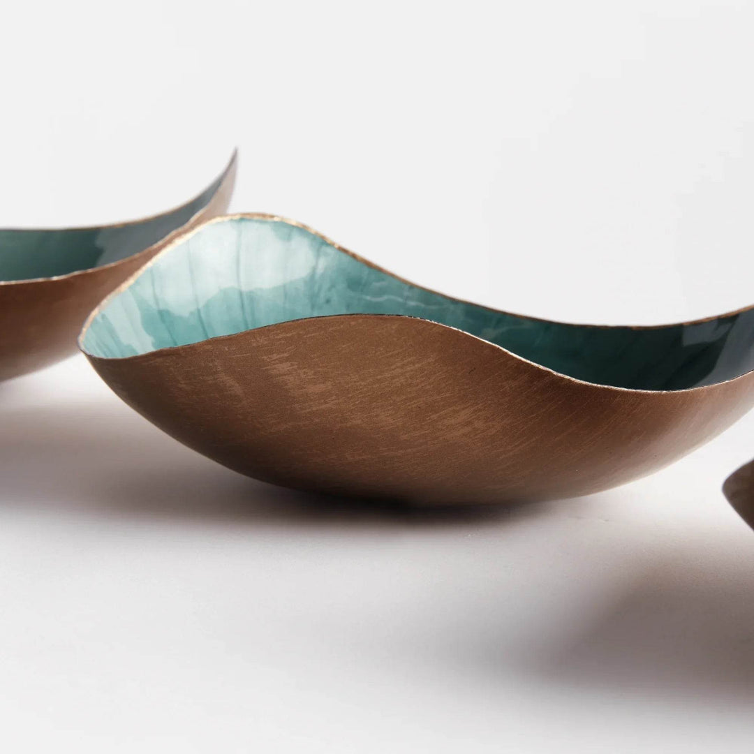 Crafted with exquisite attention to detail, these delightful coastal themed bowls infuse both sophistication and vibrancy into any setting. The gold edge embellishment and coordinating soft tones of green make them ideal for organizing small essentials while elevating the aesthetic of your home. Whether on your kitchen island, side table, or ottoman, these versatile bowls effortlessly enhance the beauty and functionality of any space.