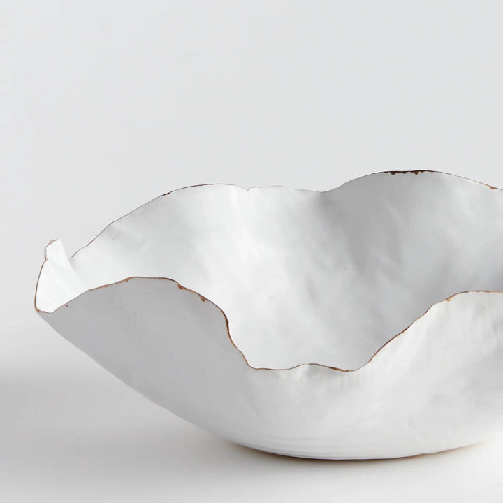 Carefully crafted with a seaside-inspired design, this large decorative tray boasts crimped edges and a natural form that is sure to make a statement in any room. Its hand-brushed gold tipped edges are electroplated for a glossy and long-lasting finish. Place it on a coffee table amongst stacked art books or on a side table for an eye-catching touch.