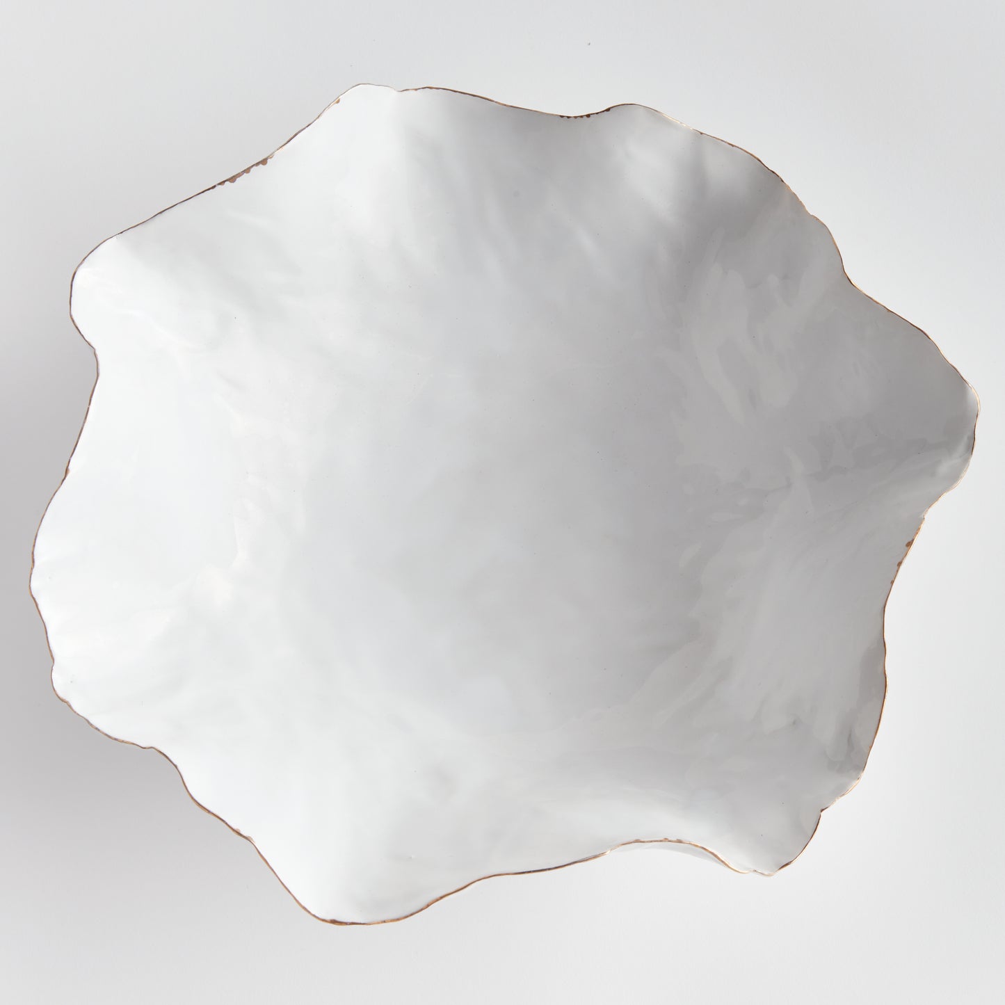 Carefully crafted with a seaside-inspired design, this large decorative tray boasts crimped edges and a natural form that is sure to make a statement in any room. Its hand-brushed gold tipped edges are electroplated for a glossy and long-lasting finish. Place it on a coffee table amongst stacked art books or on a side table for an eye-catching touch.