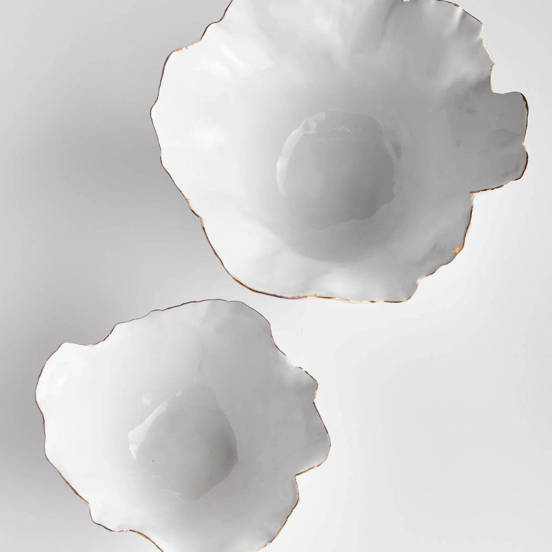 Add a touch of elegance to any room with these White Coastal Themed Decorative Bowls. The crimped edges and natural form create a stunning centerpiece, while the hand-brushed gold tipped edges add shine and durability thanks to the electroplating process. Whether displayed on a coffee table with art books or on a side table, these bowls are both functional and beautiful.