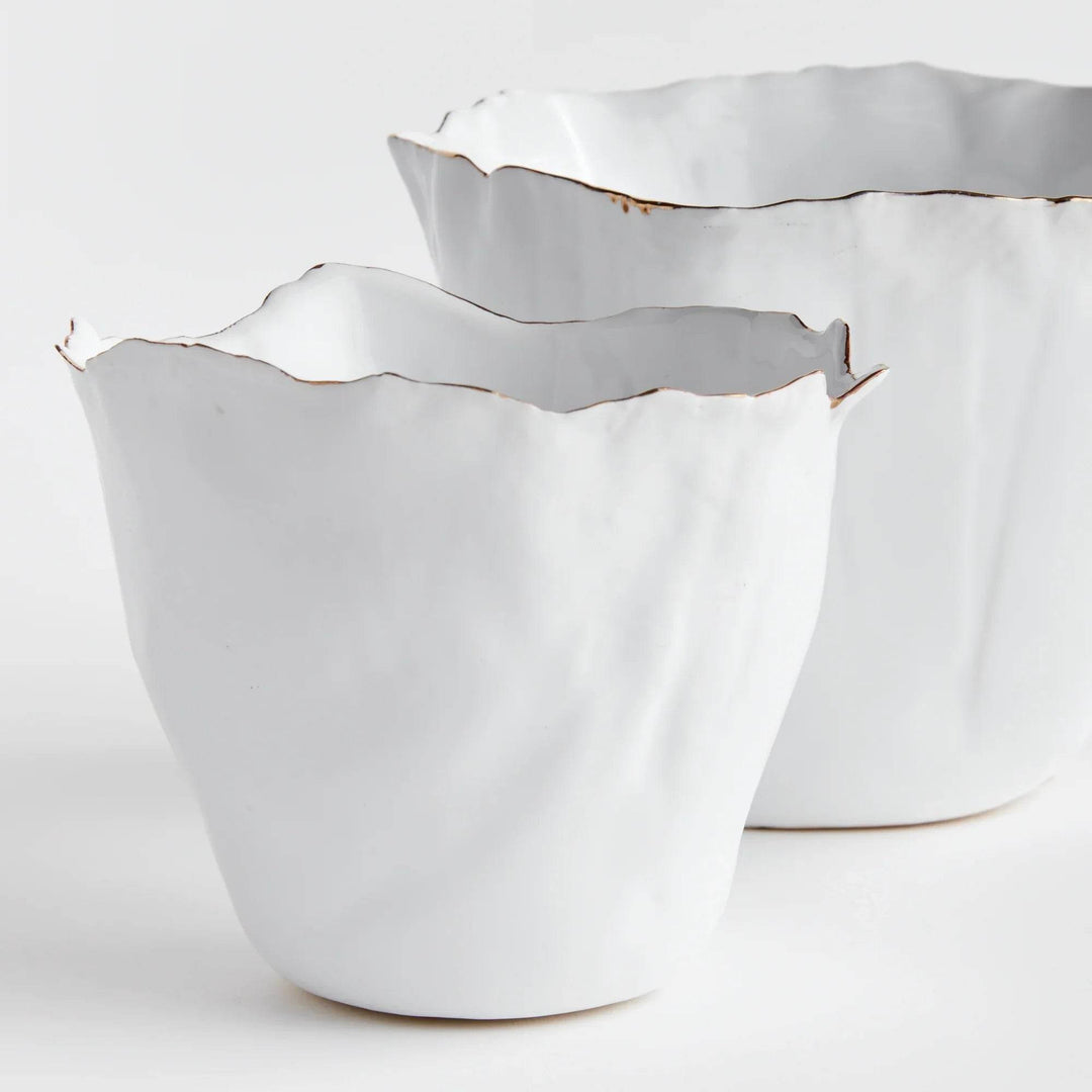Our White Cachepots Planters feature crimped edges and a natural form, making them the perfect statement-making centerpiece. The hand-brushed gold tipped edges are electroplated for lasting shine and durability. Add your favorite orchid to elevate your home decor game.