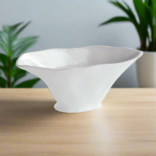 Enhance the aesthetic of any space with this coastal themed white oval vase. Its sculptural form and slim profile are ideal for a narrow console or mantle. Add elegance by draping faux stems or filling it with decorative orbs. Create a unique focal point and elevate your home decor effortlessly.