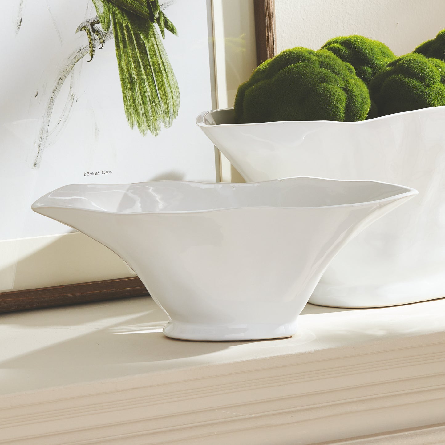 Enhance the aesthetic of any space with this coastal themed white oval vase. Its sculptural form and slim profile are ideal for a narrow console or mantle. Add elegance by draping faux stems or filling it with decorative orbs. Create a unique focal point and elevate your home decor effortlessly.