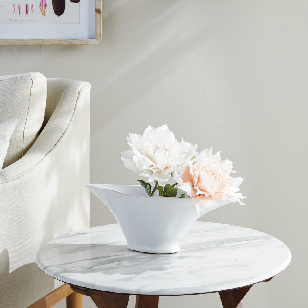 Enhance the aesthetic of any space with this coastal themed white oval vase. Its sculptural form and slim profile are ideal for a narrow console or mantle. Add elegance by draping faux stems or filling it with decorative orbs. Create a unique focal point and elevate your home decor effortlessly.