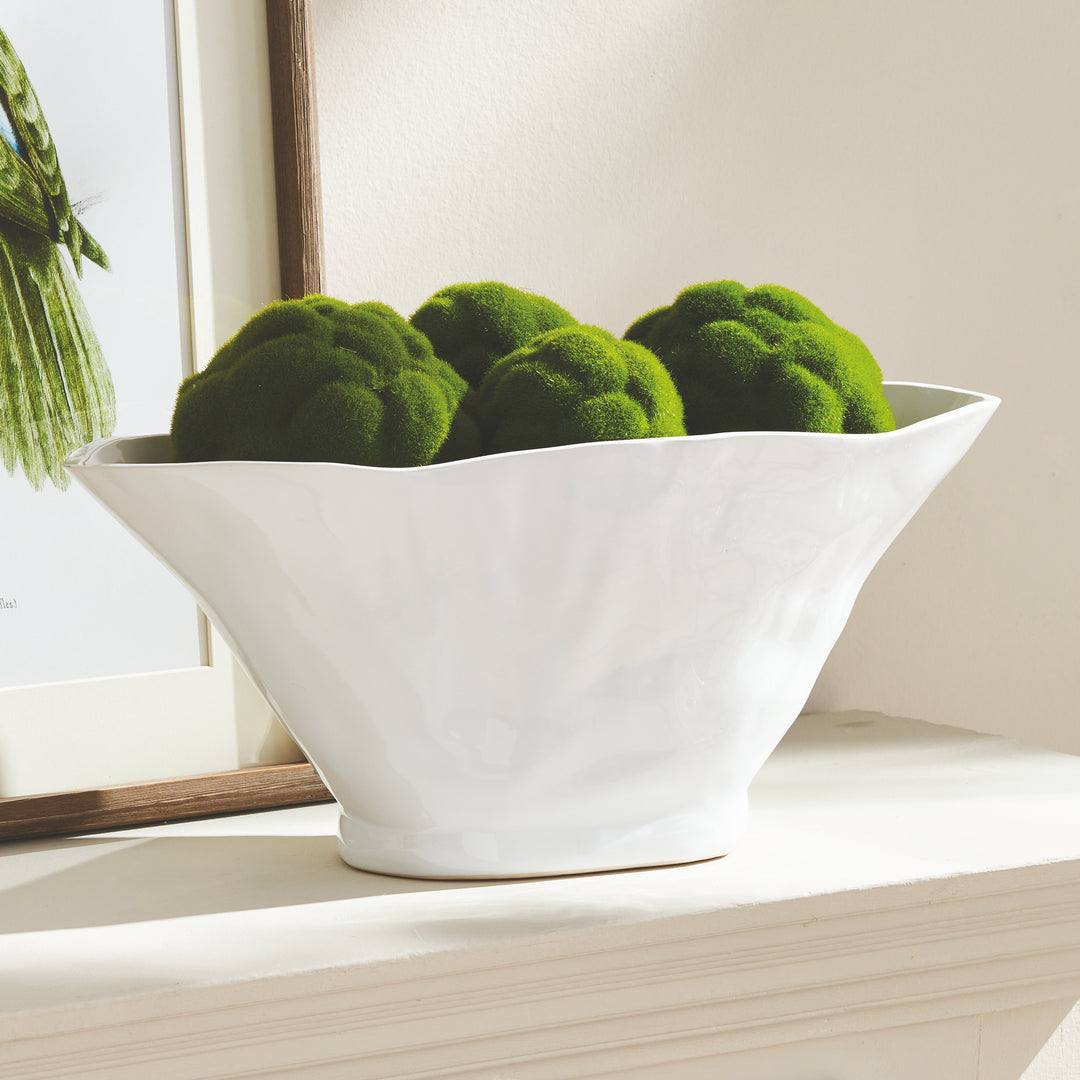 Enhance any space with the sleek and versatile design of the Coastal White Oval Vase Large. With its sculptural form and slim profile, it's perfect for narrow consoles or mantles. Add a faux stem or a few decorative orbs for a sophisticated touch.