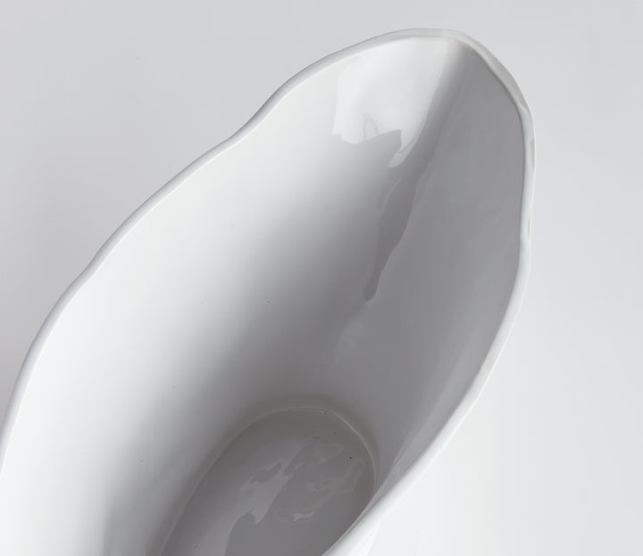 Enhance any space with the sleek and versatile design of the Coastal White Oval Vase Large. With its sculptural form and slim profile, it's perfect for narrow consoles or mantles. Add a faux stem or a few decorative orbs for a sophisticated touch.