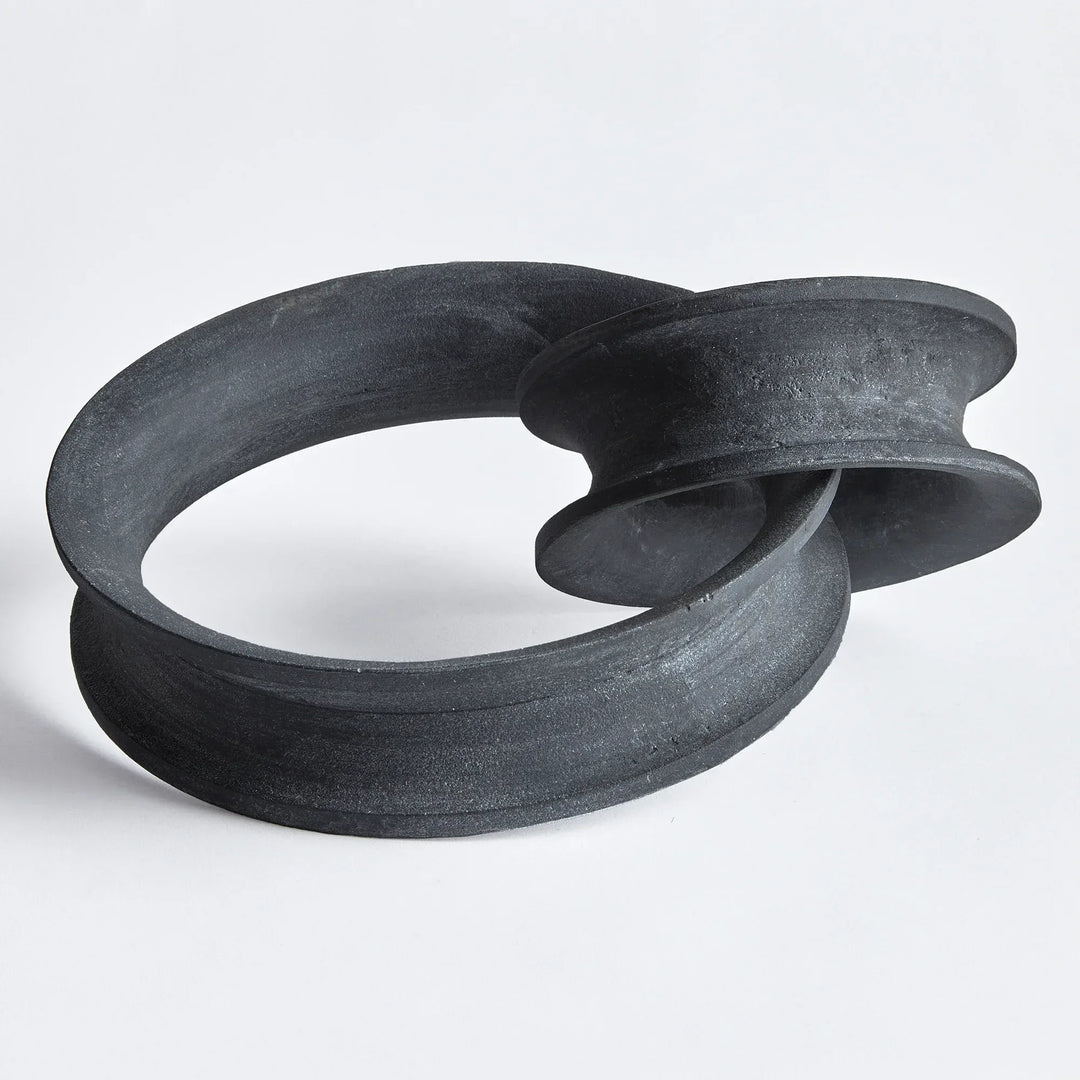 Black abstract sculpture on a white background
