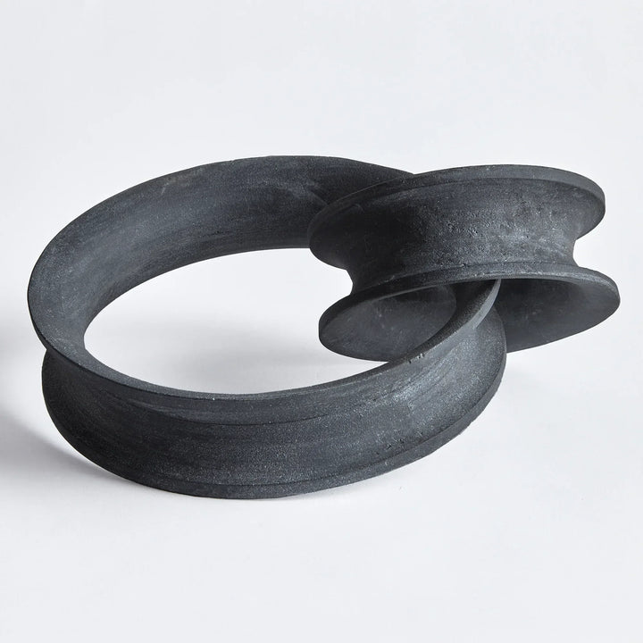 Black abstract sculpture on a white background