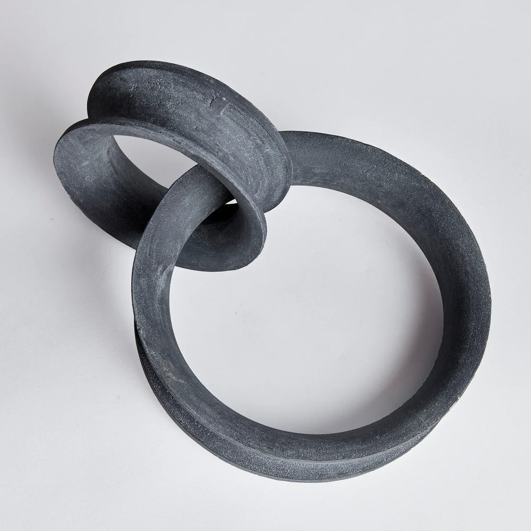 Two interlocking black rings on a light gray background