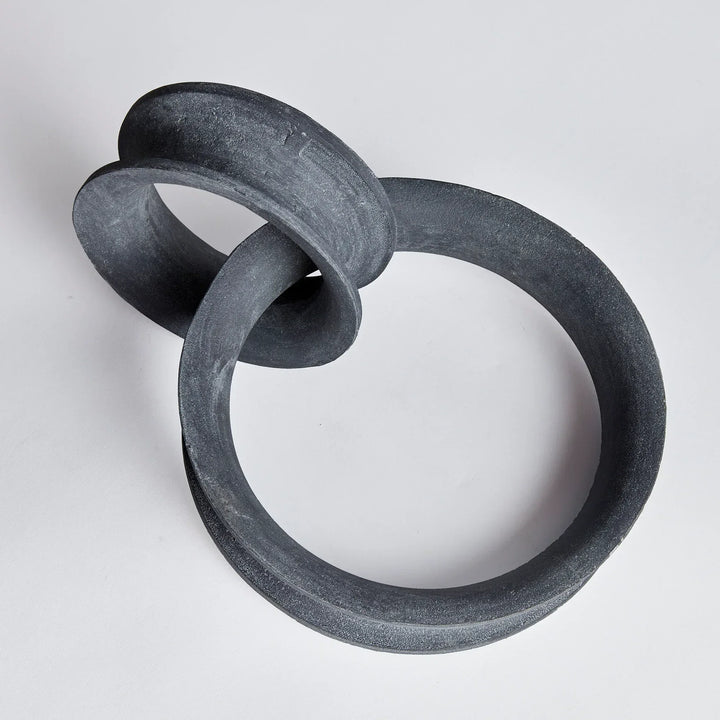 Two interlocking black rings on a light gray background