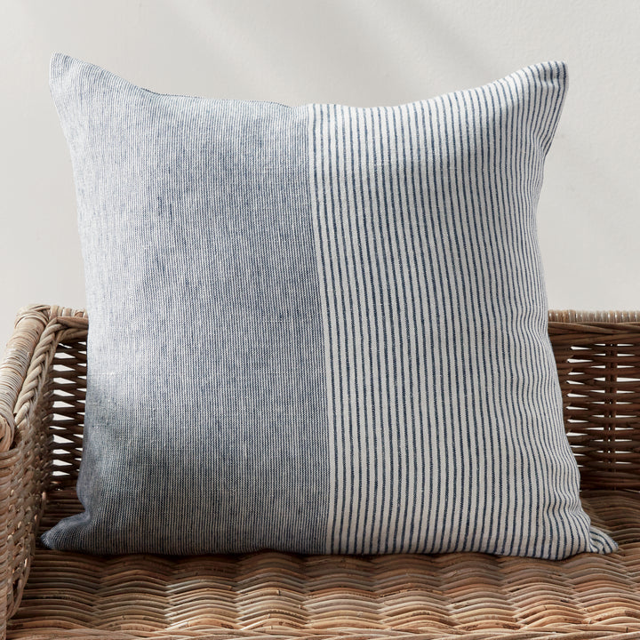 Side view of 24-inch navy and ivory striped linen pillow showing textured weave and piping


