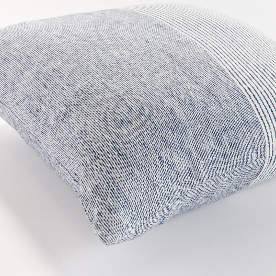 Close-up of navy and ivory pinstripe linen pillow with visible linen texture and soft fold


