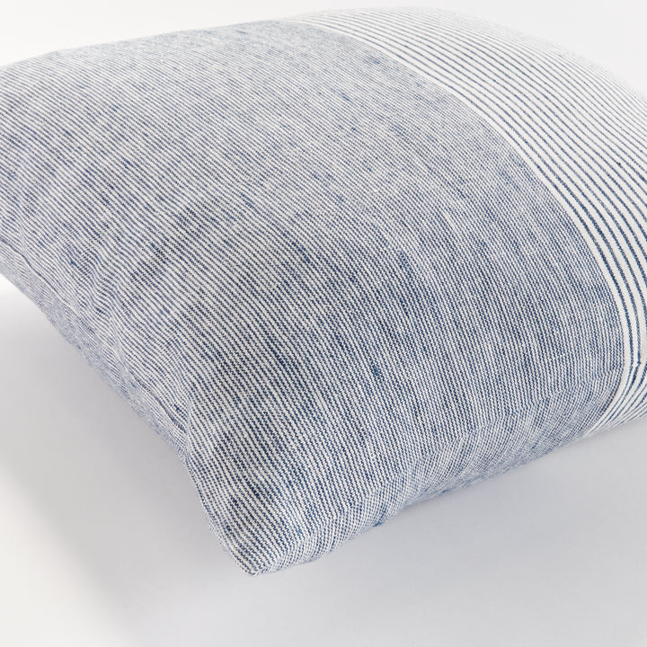 Close-up of navy and ivory pinstripe linen pillow with visible linen texture and soft fold


