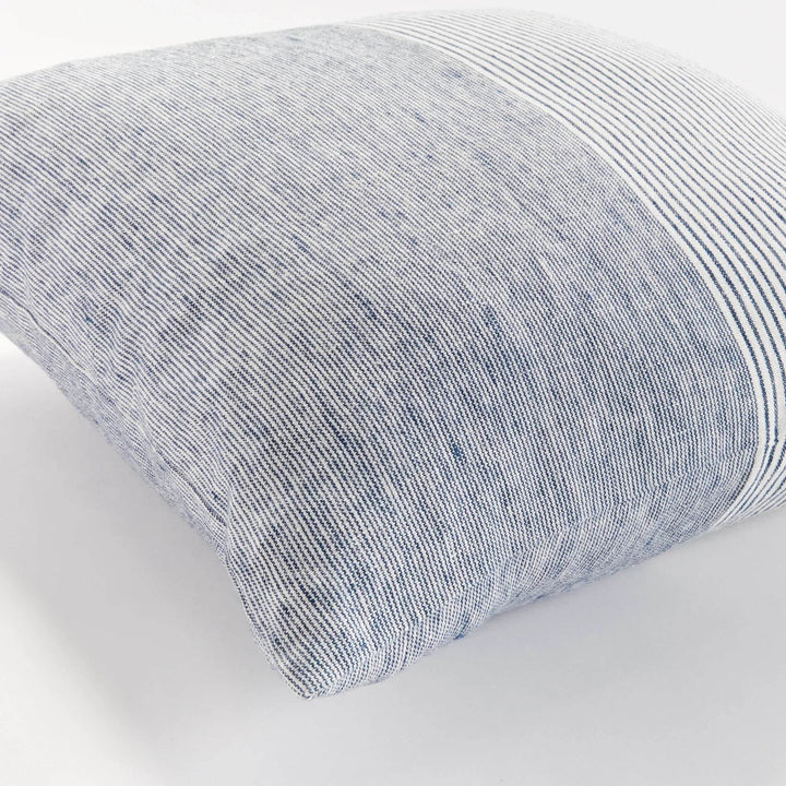 Close-up of navy and ivory pinstripe linen pillow with visible linen texture and soft fold


