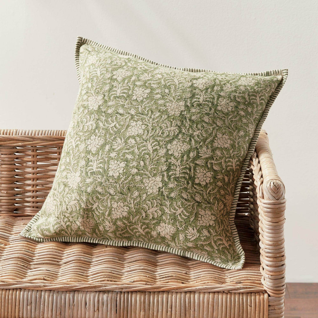 European flax pillow fabric detail showing the natural slub texture and yarn-dyed pinstripe pattern in soft green and flax—crafted for organic elegance.

