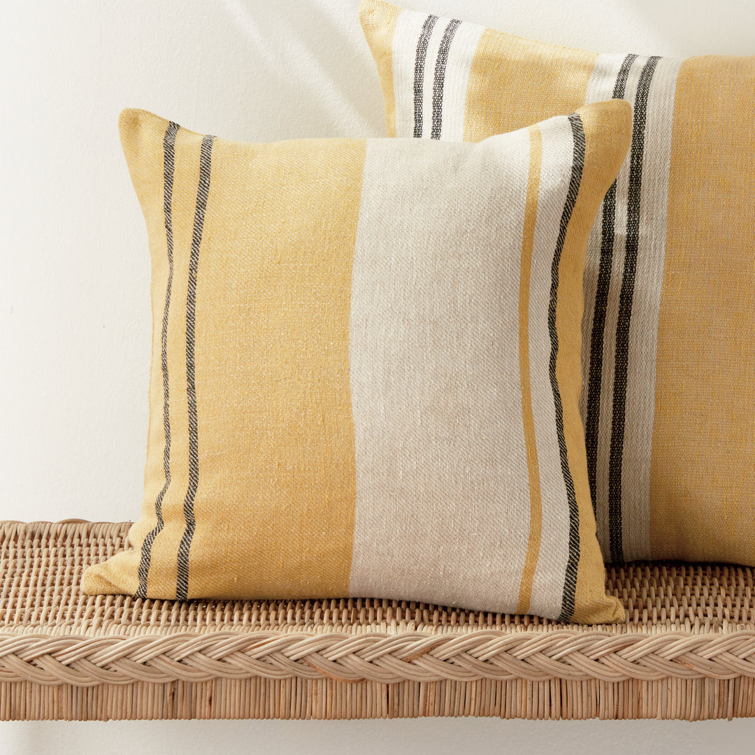 Yellow striped linen pillow with down insert styled in coastal living room décor
