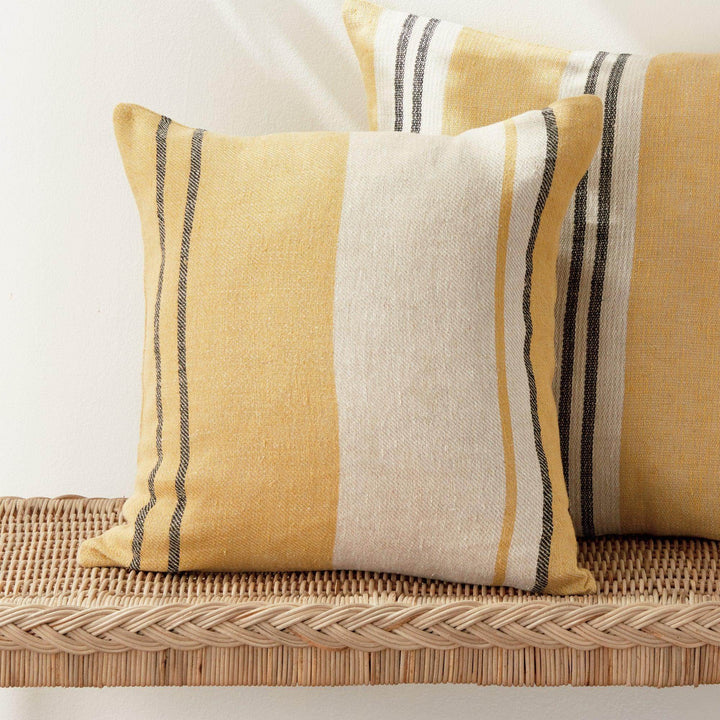 Yellow striped linen pillow with down insert styled in coastal living room décor
