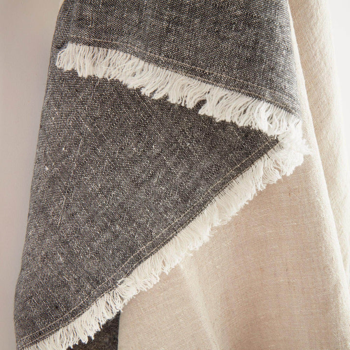Folded stack of linen throws including flax and charcoal 60x50 blanket



