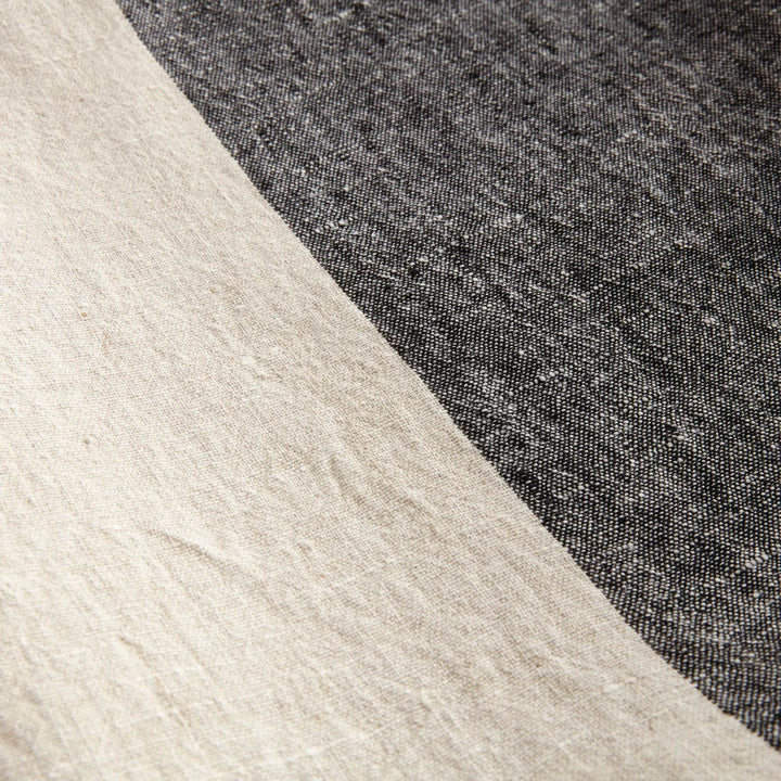 Macro detail of charcoal stripe pattern on natural flax linen fabric

