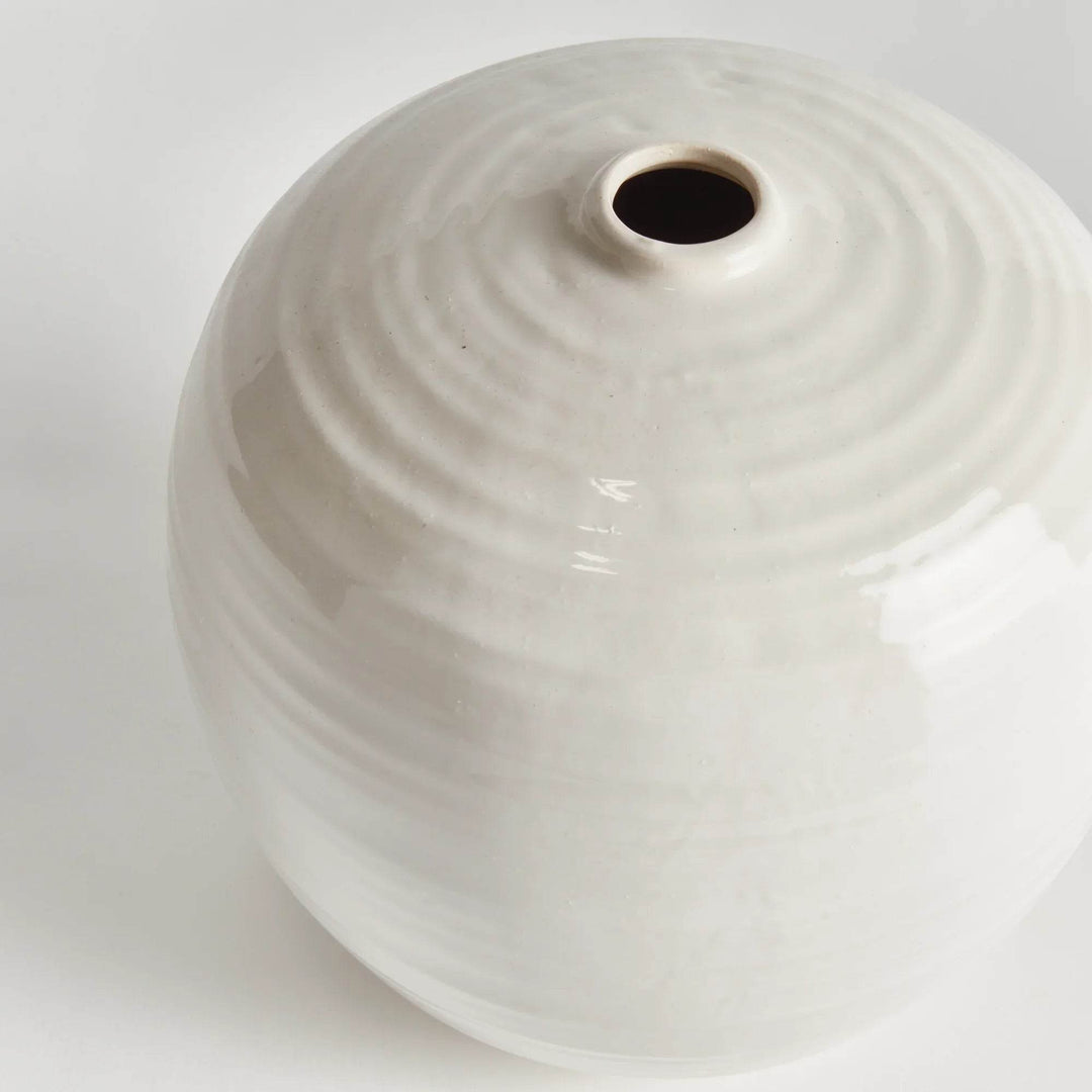 Detailed close-up of reactive glaze on oatmeal-colored vase, highlighting the artisanal finish and handmade character