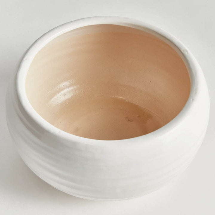 Oatmeal stoneware decorative bowl with a wide, shallow profile and reactive glaze finish, shown at an angle on white background.