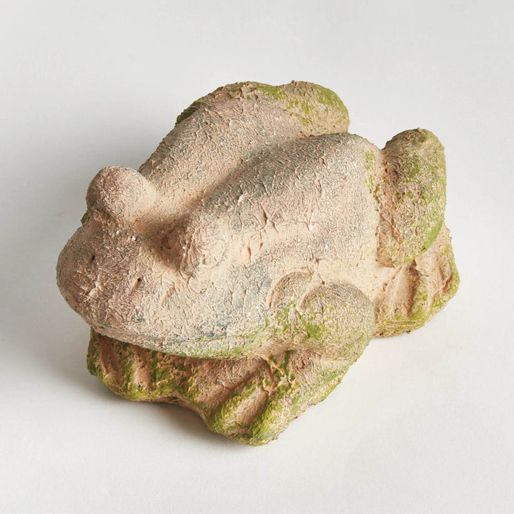 Back view of weathered terracotta frog statue showing aged green glaze and natural textural imperfections.

