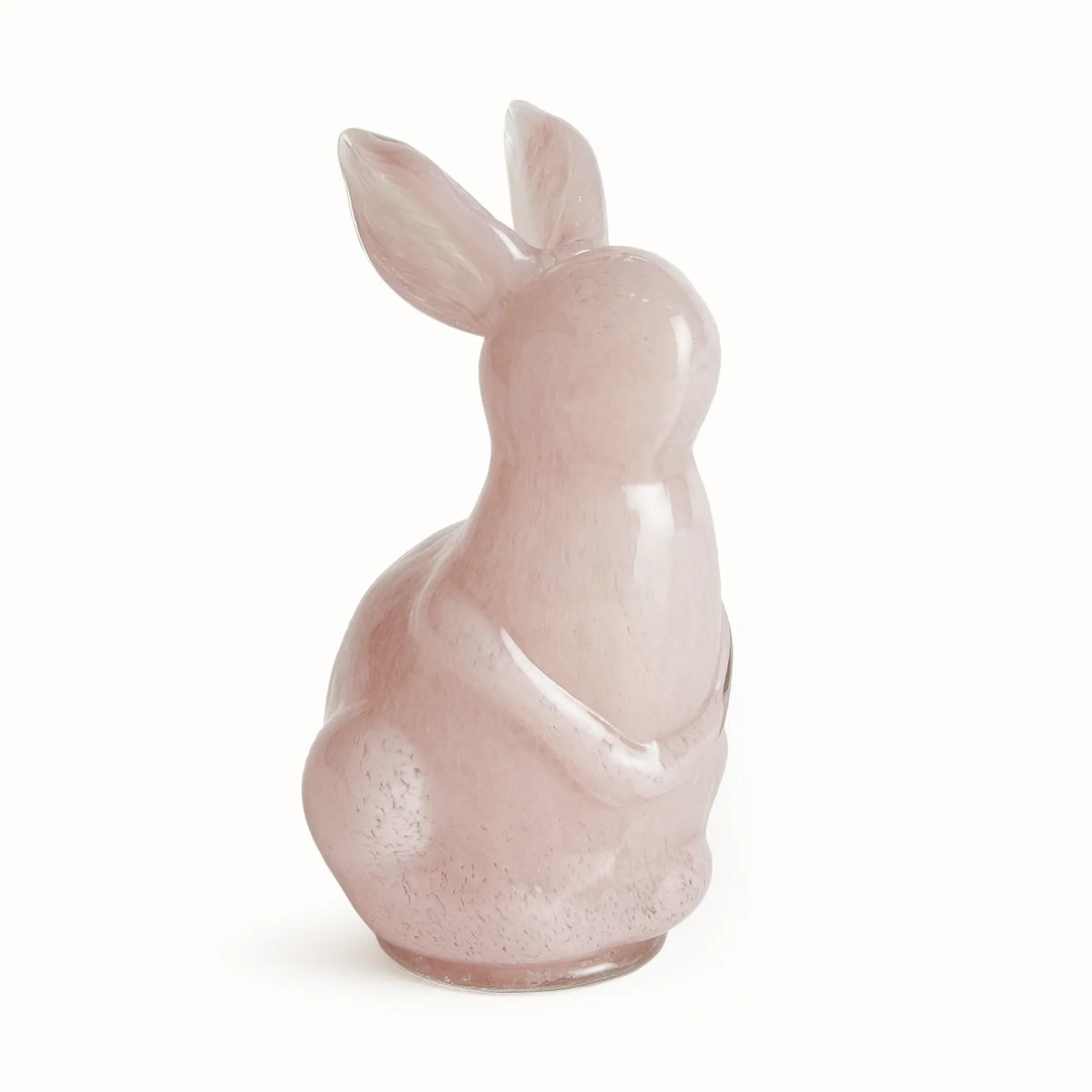 Pink glass rabbit figurine on a white background