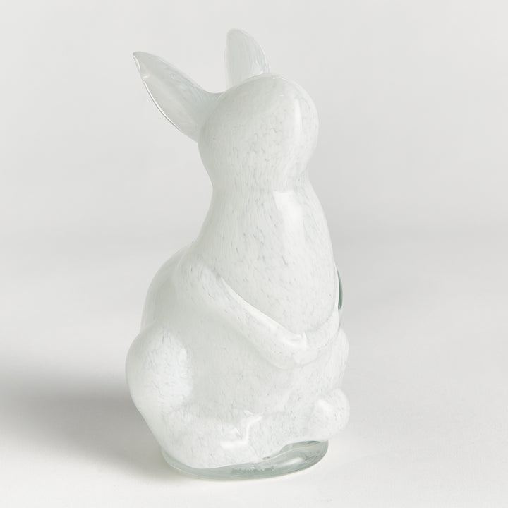 White hand blown glass rabbit figurine on a light gray background