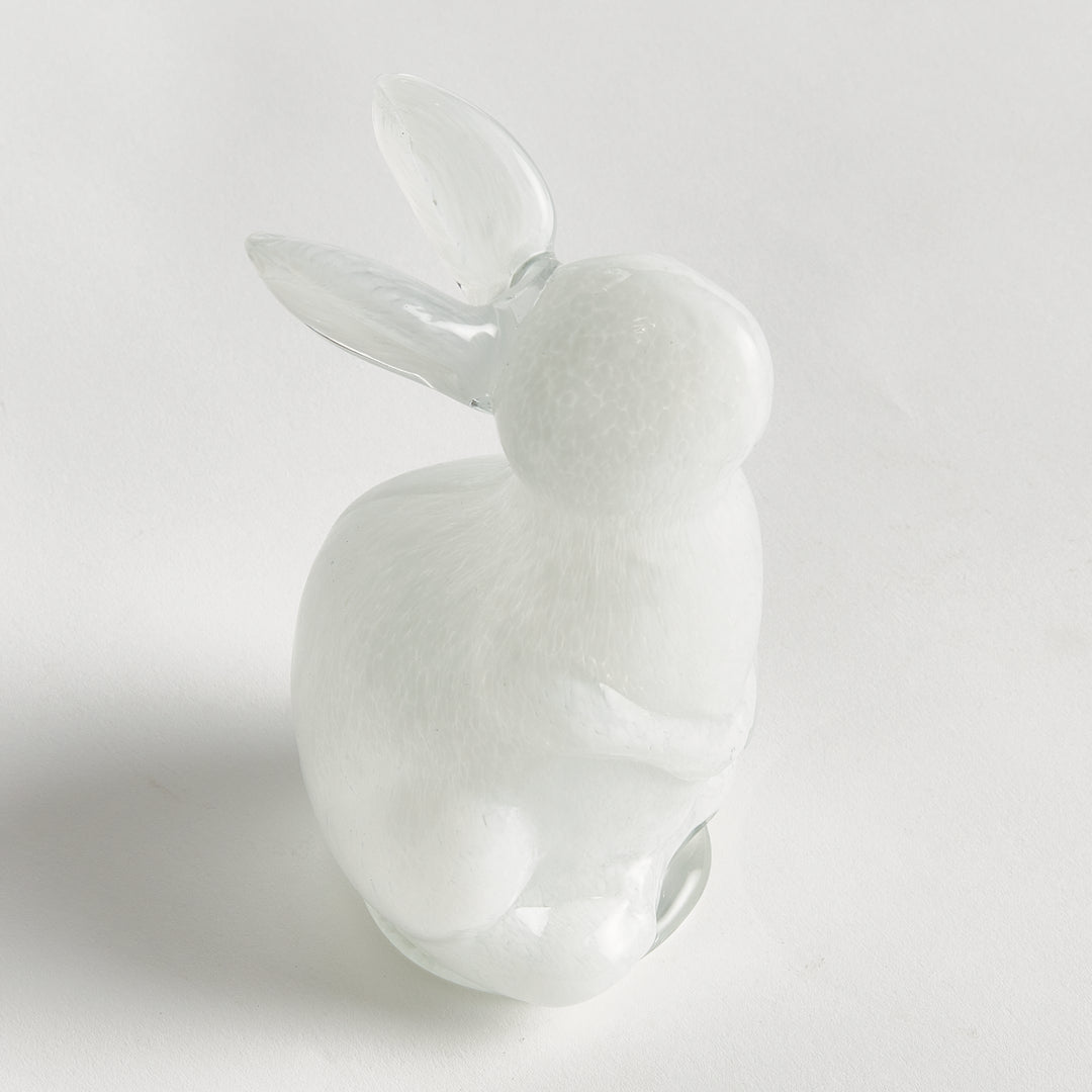 White hand blown glass rabbit on a light gray background
