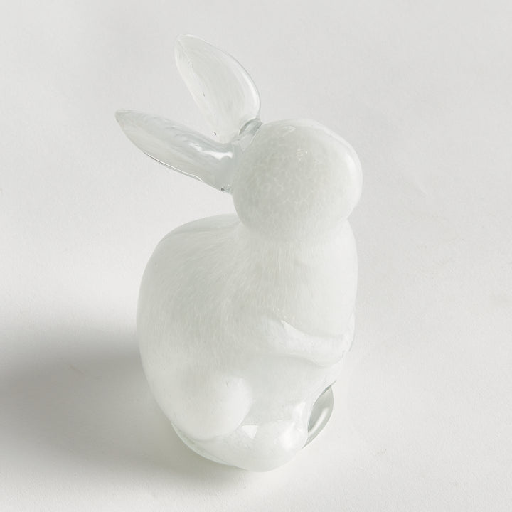 White hand blown glass rabbit on a light gray background