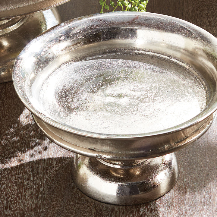 Silver pedestal bowl on a wooden surface