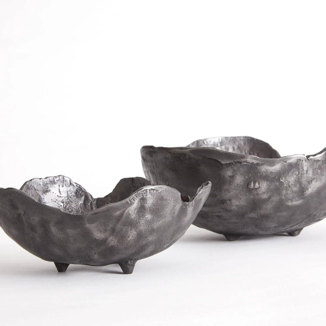 Two black aluminum bowls on a white background