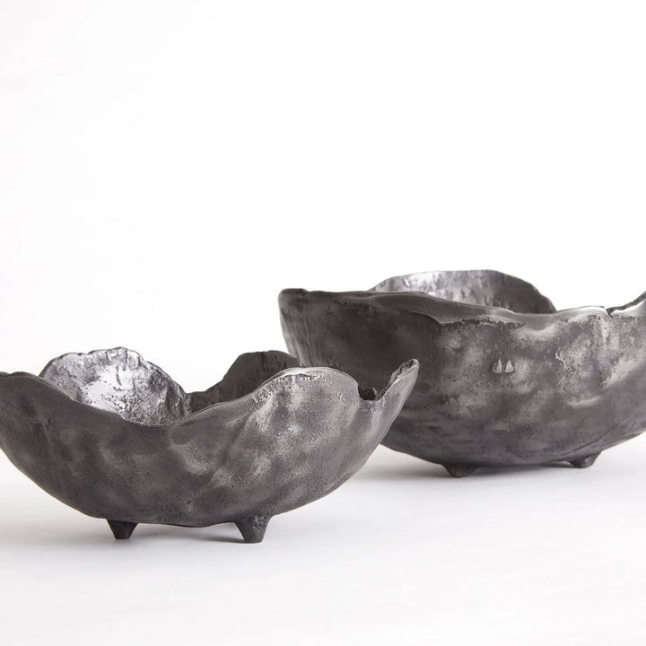 Two black aluminum bowls on a white background