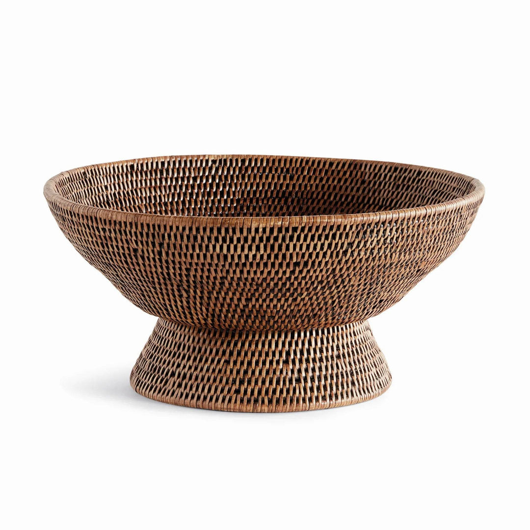 Warm brown woven rattan pedestal offering bowl shown from the front with its raised round base and wide rim, Transitional