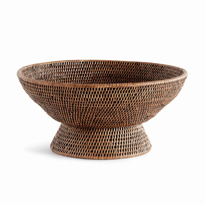 Warm brown woven rattan pedestal offering bowl shown from the front with its raised round base and wide rim, Transitional